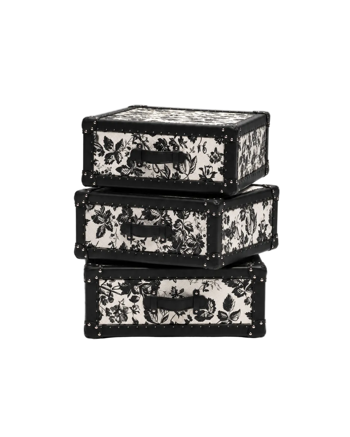 Three stacked vintage-style trunk boxes with black floral patterns on a white background, featuring black handles and metal corner rivets, photographed on a light gray studio background.
