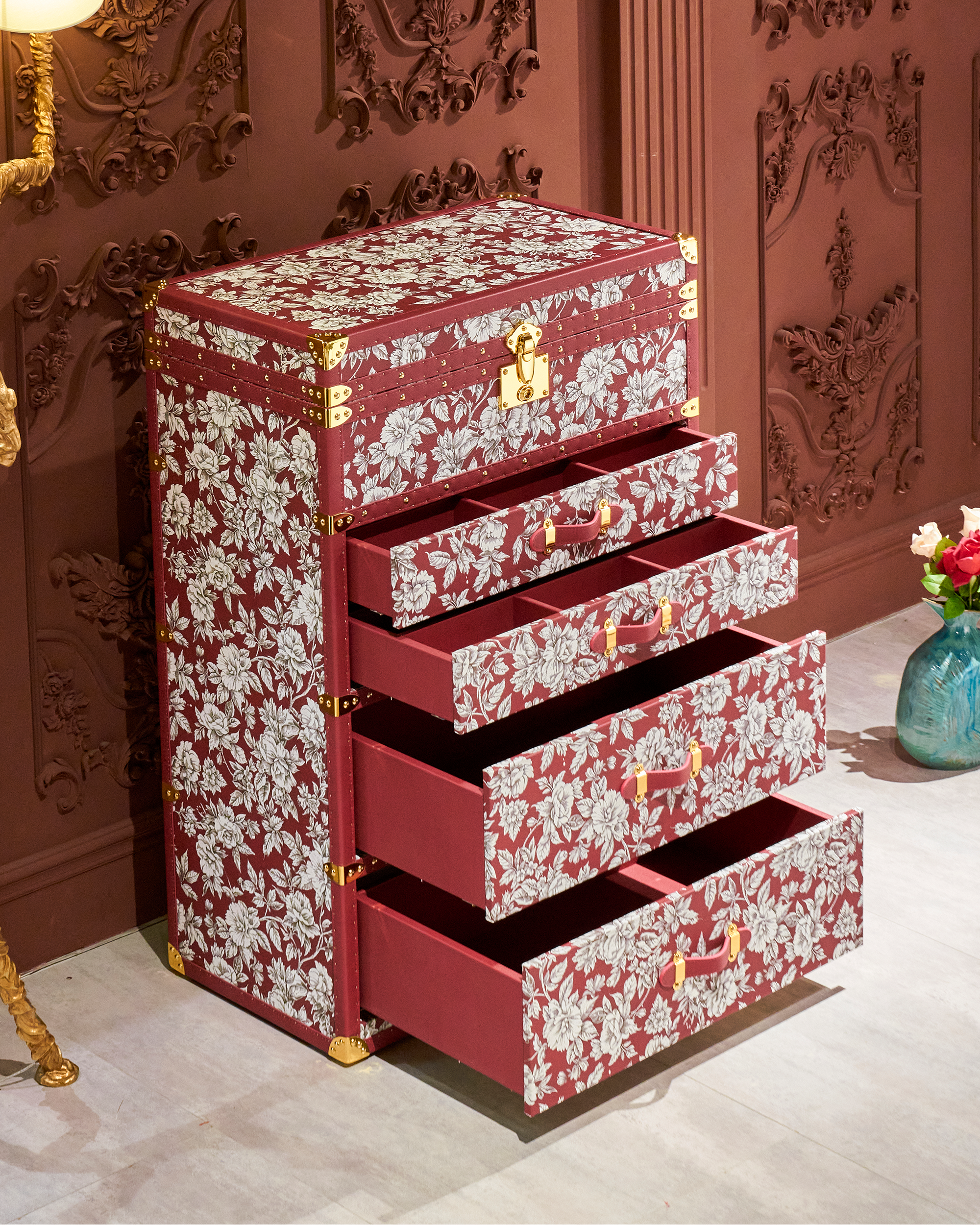 SIRAE Heritage Luxe red floral print jewelry trunk styled with jewelry in a luxury Dubai interior