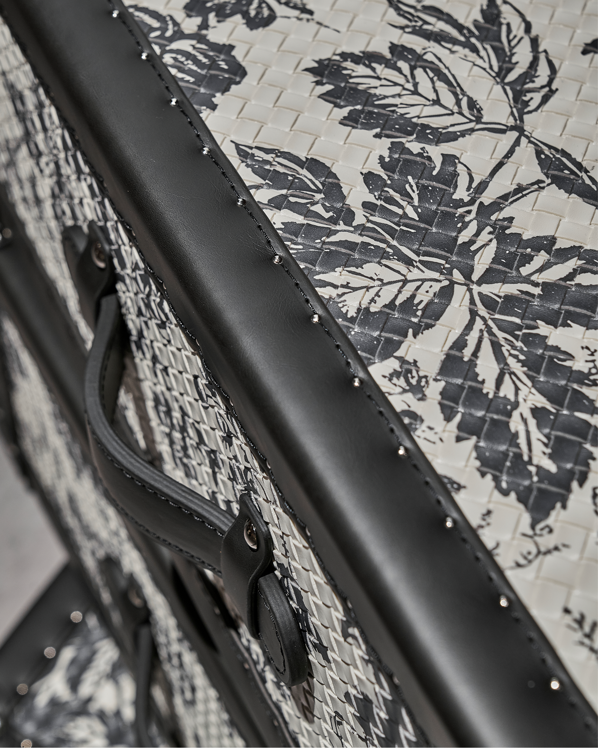 Hand-stitched full-grain leather detail on the SIRAE monochrome rotating cabinet