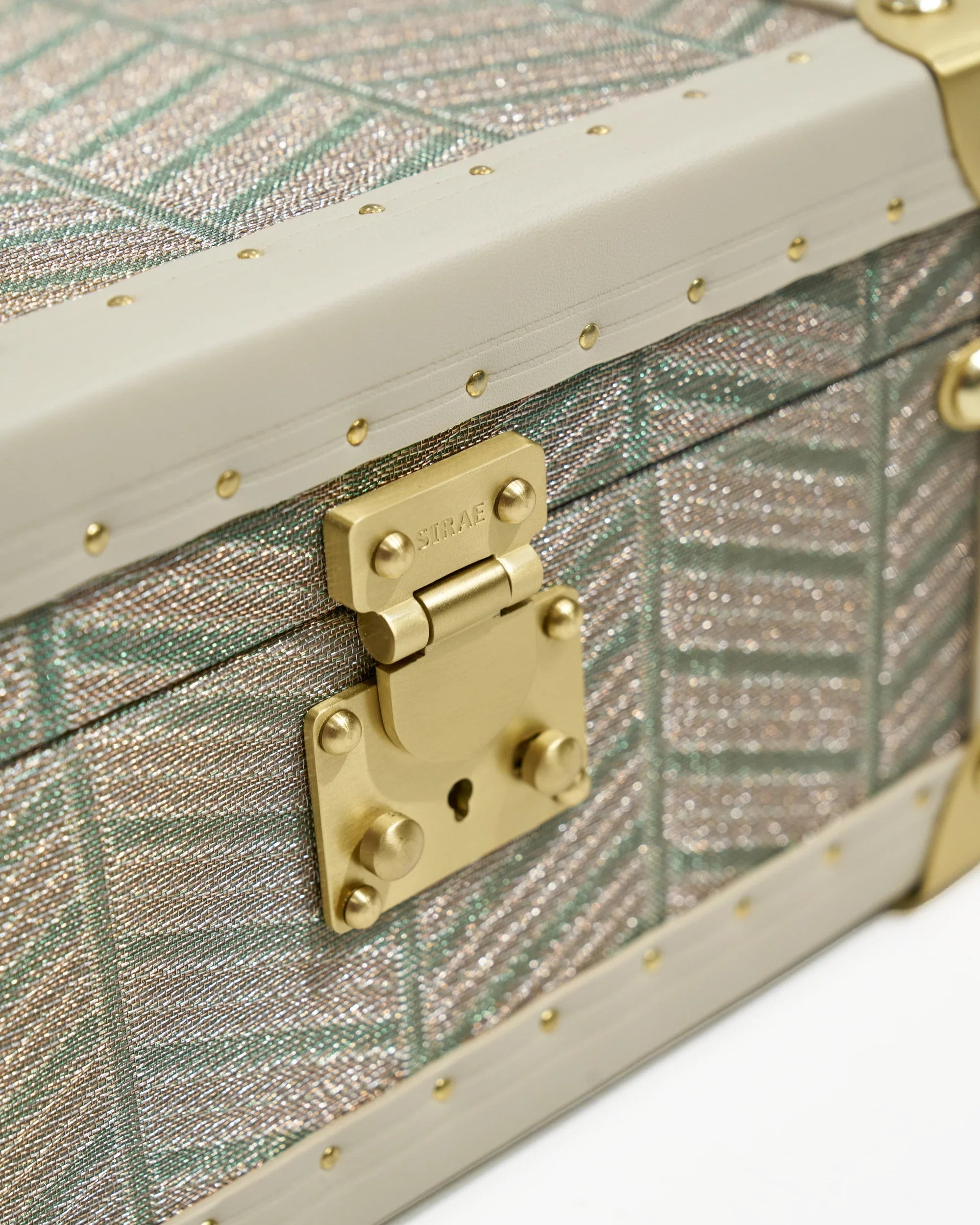 Side view of the SIRAE Aurum Loom avocado green jewelry box in a luxury Dubai setting