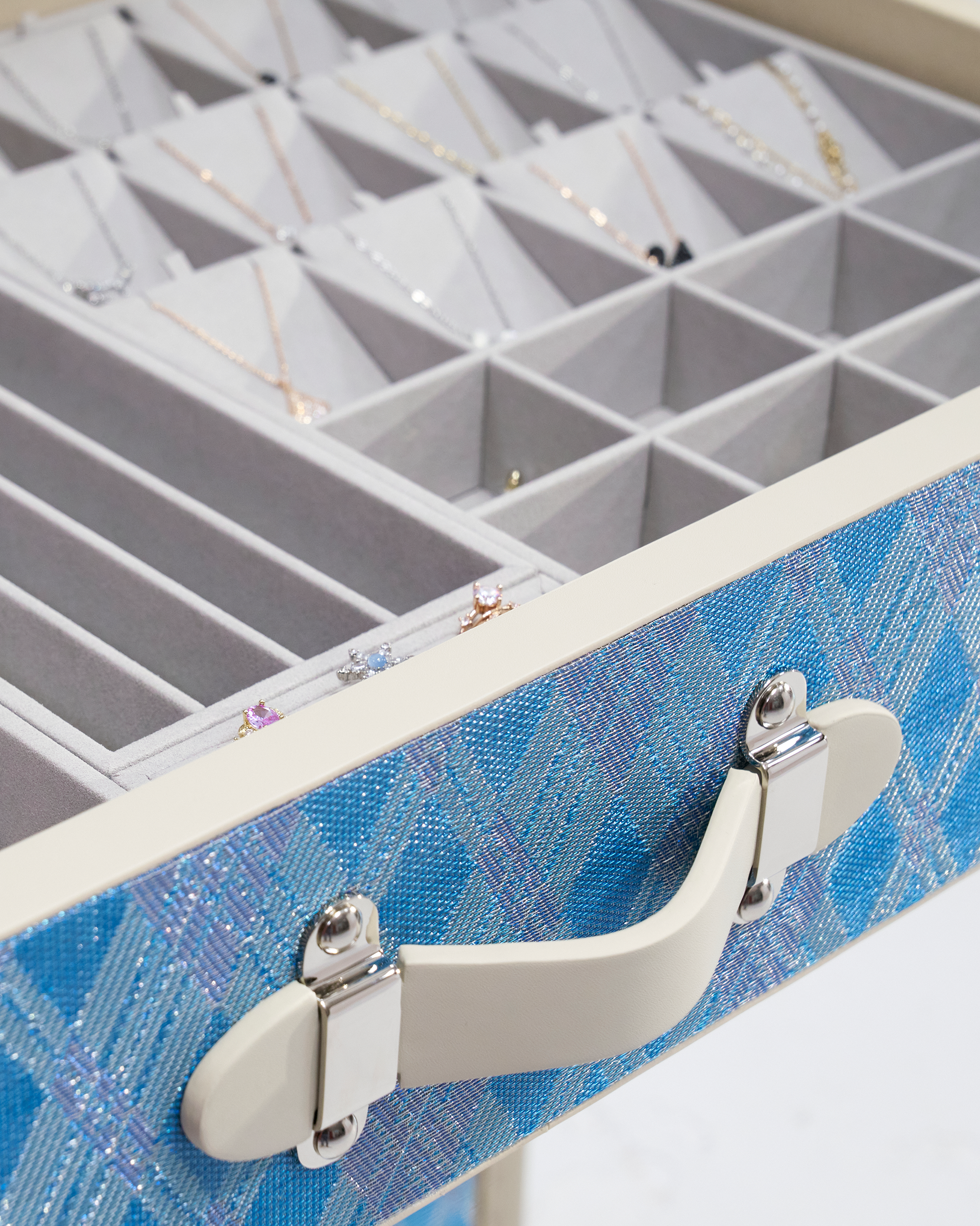 SIRAE Aurum Loom diamond mist blue jewelry cabinet styled with jewelry in a luxury Dubai interior
