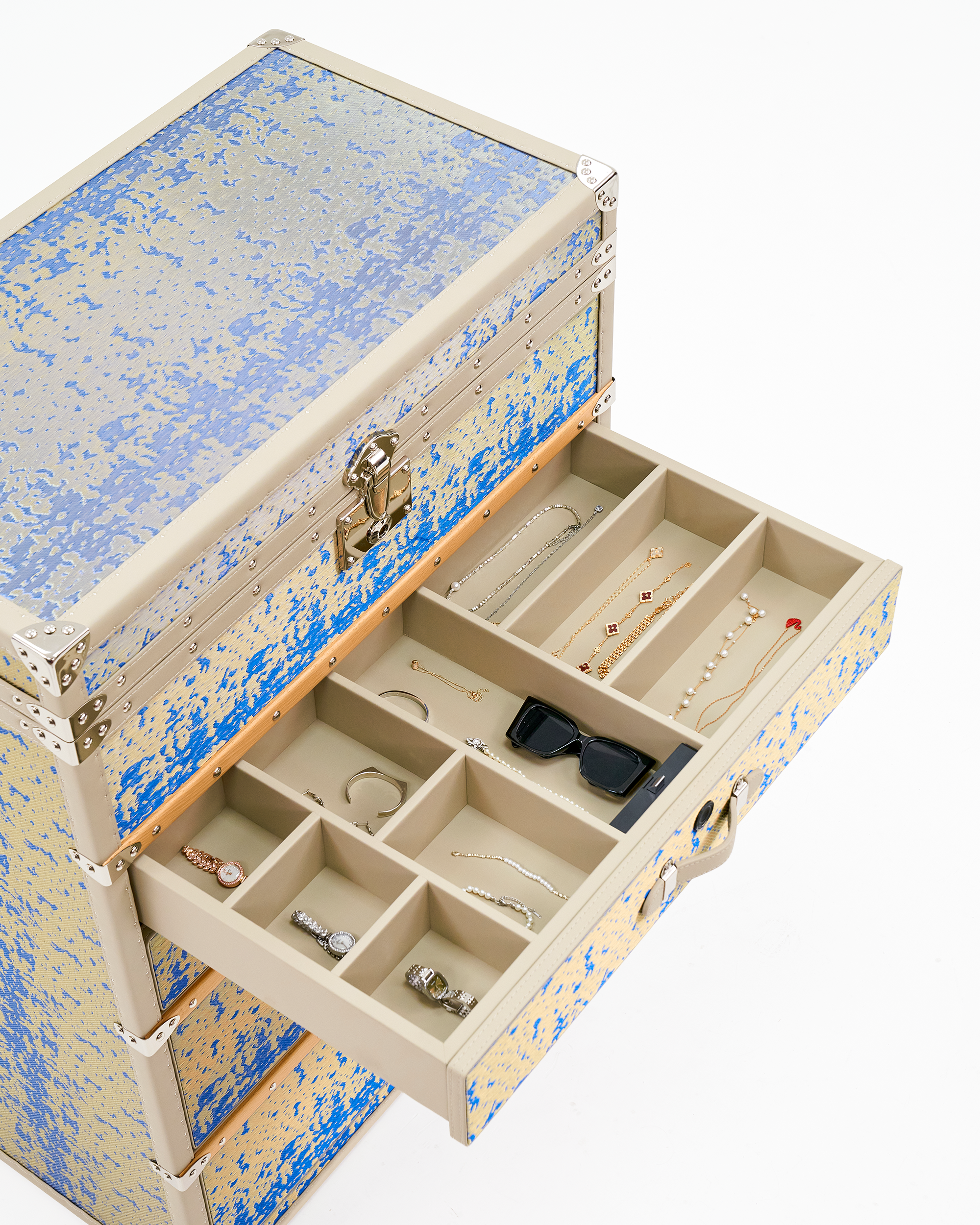Velvet-lined jewelry compartments inside the SIRAE Aurum Loom Gilded Blue biometric trunk, styled for heirloom storage