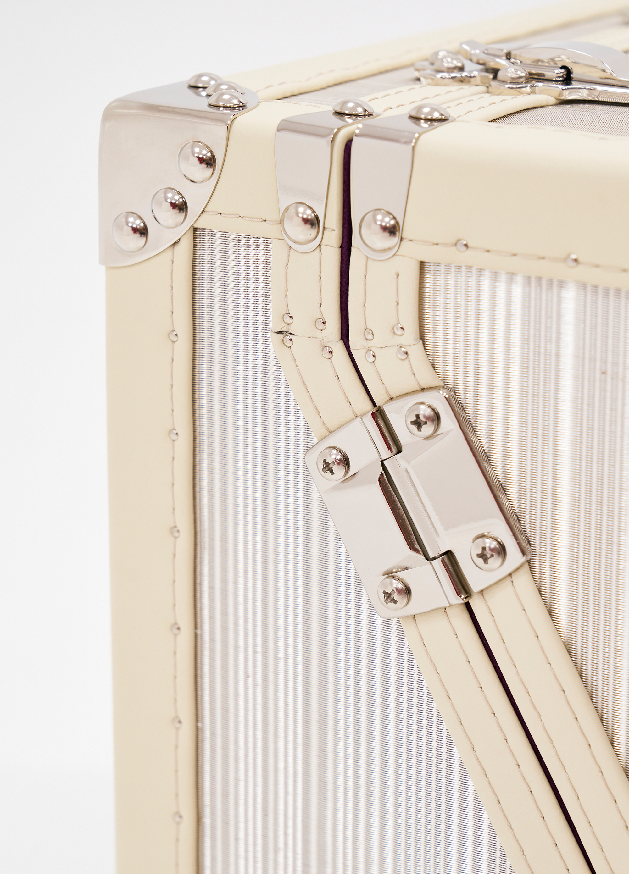 SIRAE Aurum Loom frosted silver necklace display case styled with jewelry in a luxury Dubai interior