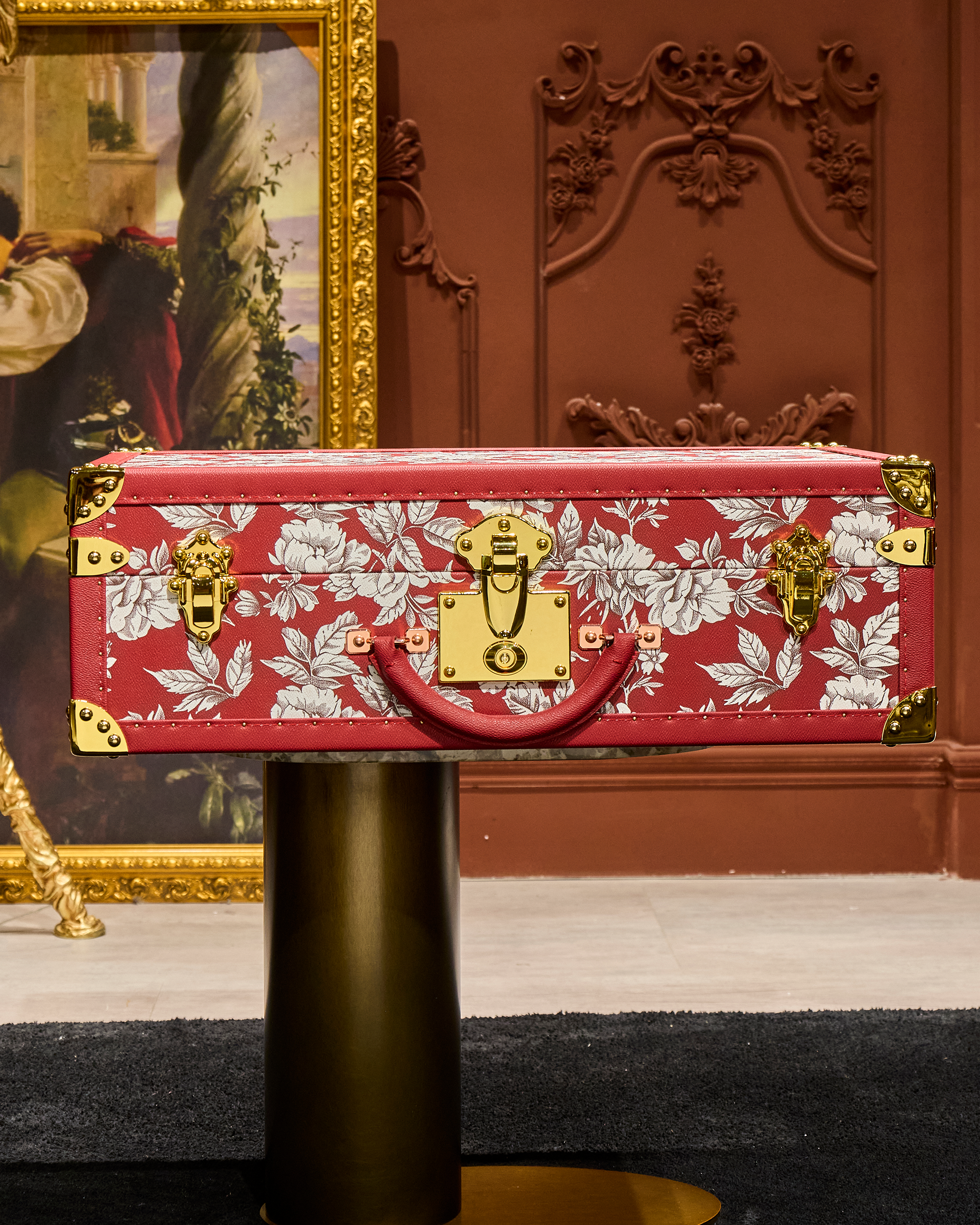 SIRAE Heritage Luxe red tower case styled with jewelry in a luxury Dubai interior