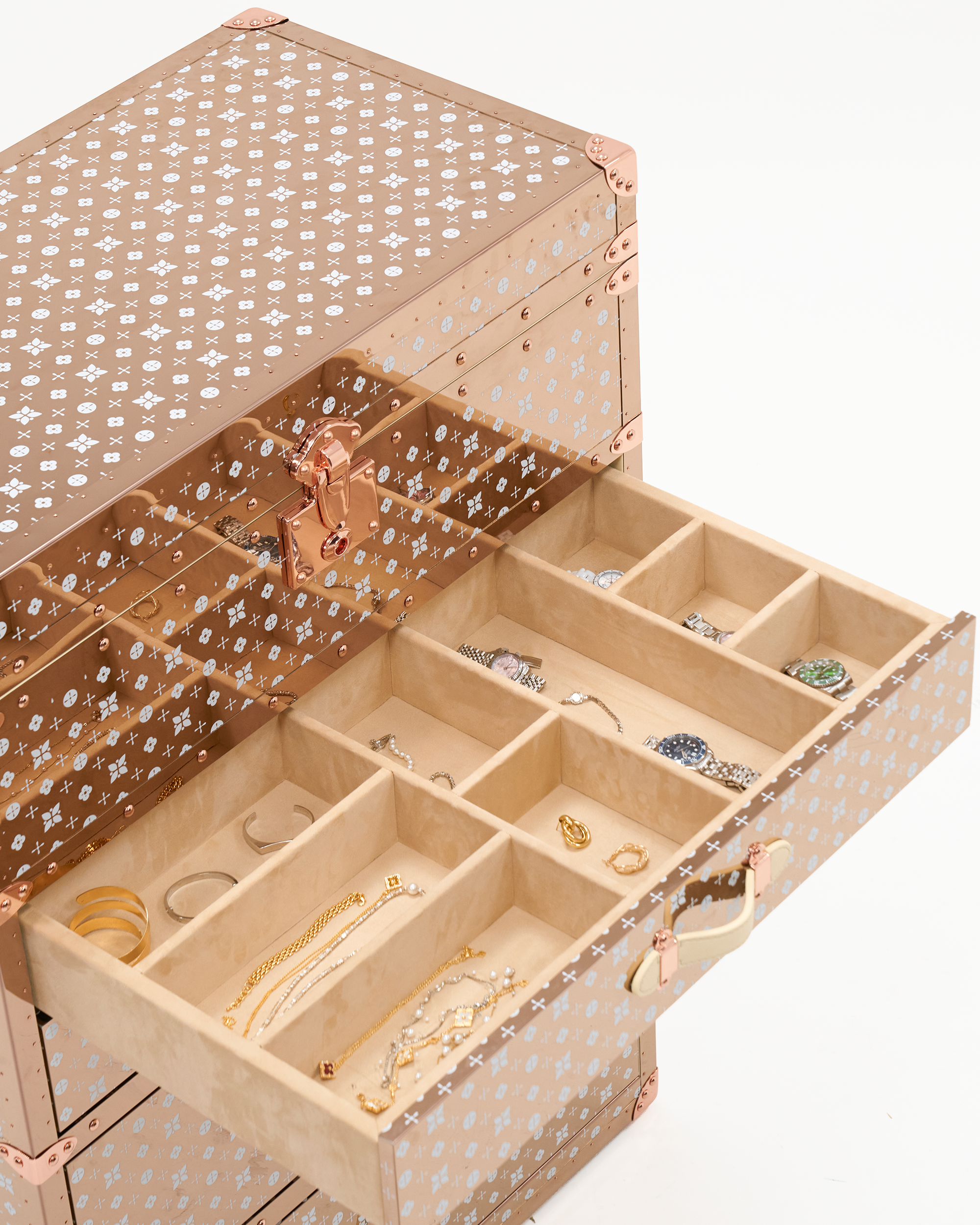 Velvet-lined interior of the SIRAE Lumière Atelier rose gold jewelry trunk, styled for luxury storage