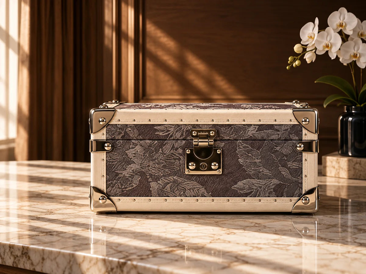 SIRAE patterned personal case with polished hardware in an architectural setting
